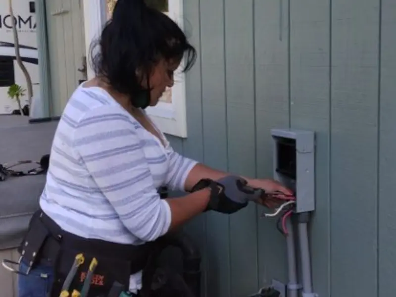 Licensed electrician wiring an exterior subpanel in Oak Grove